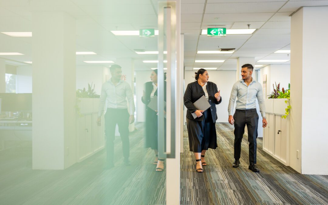 Colleagues Walking Through a Corporate Office