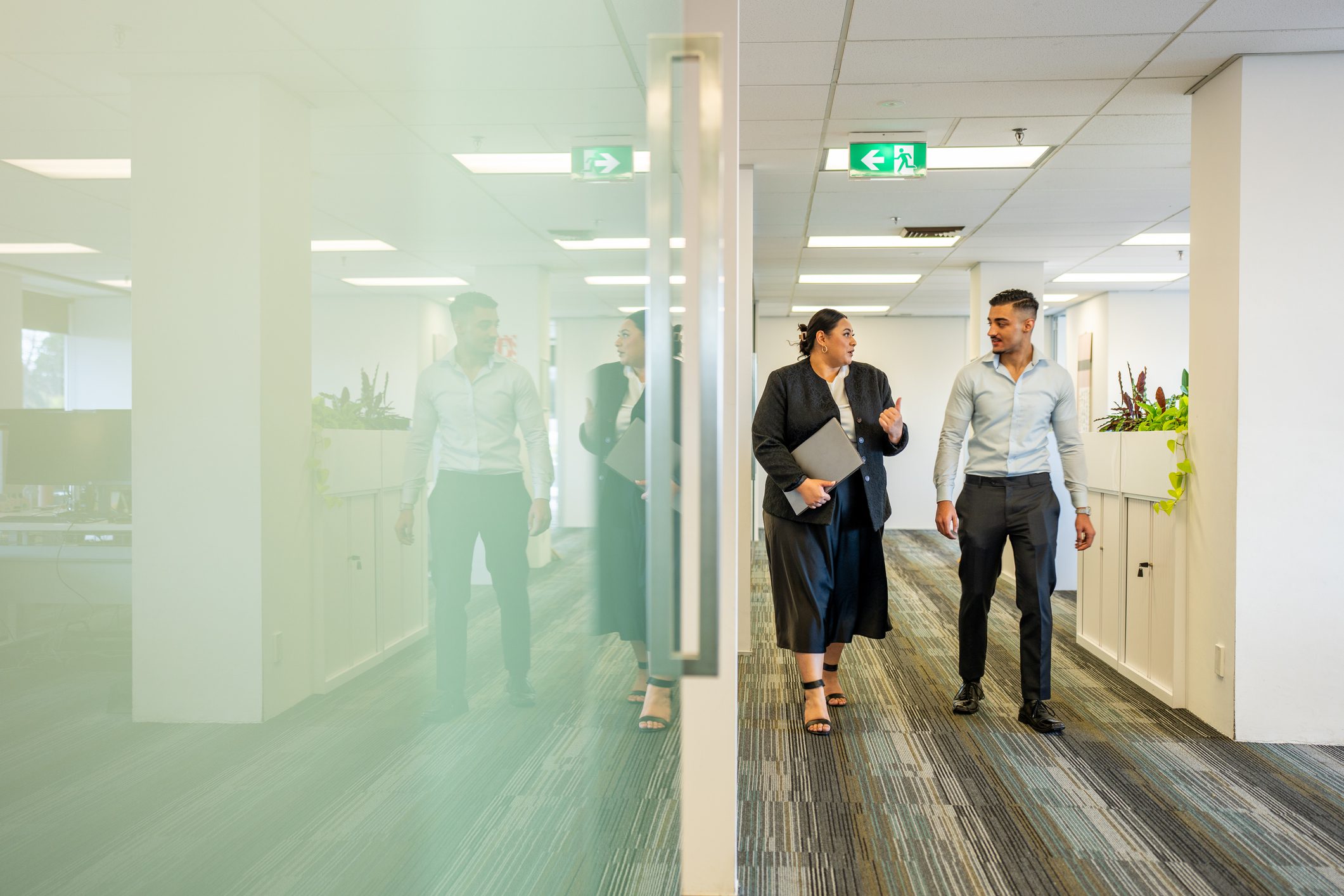 Colleagues Walking Through a Corporate Office